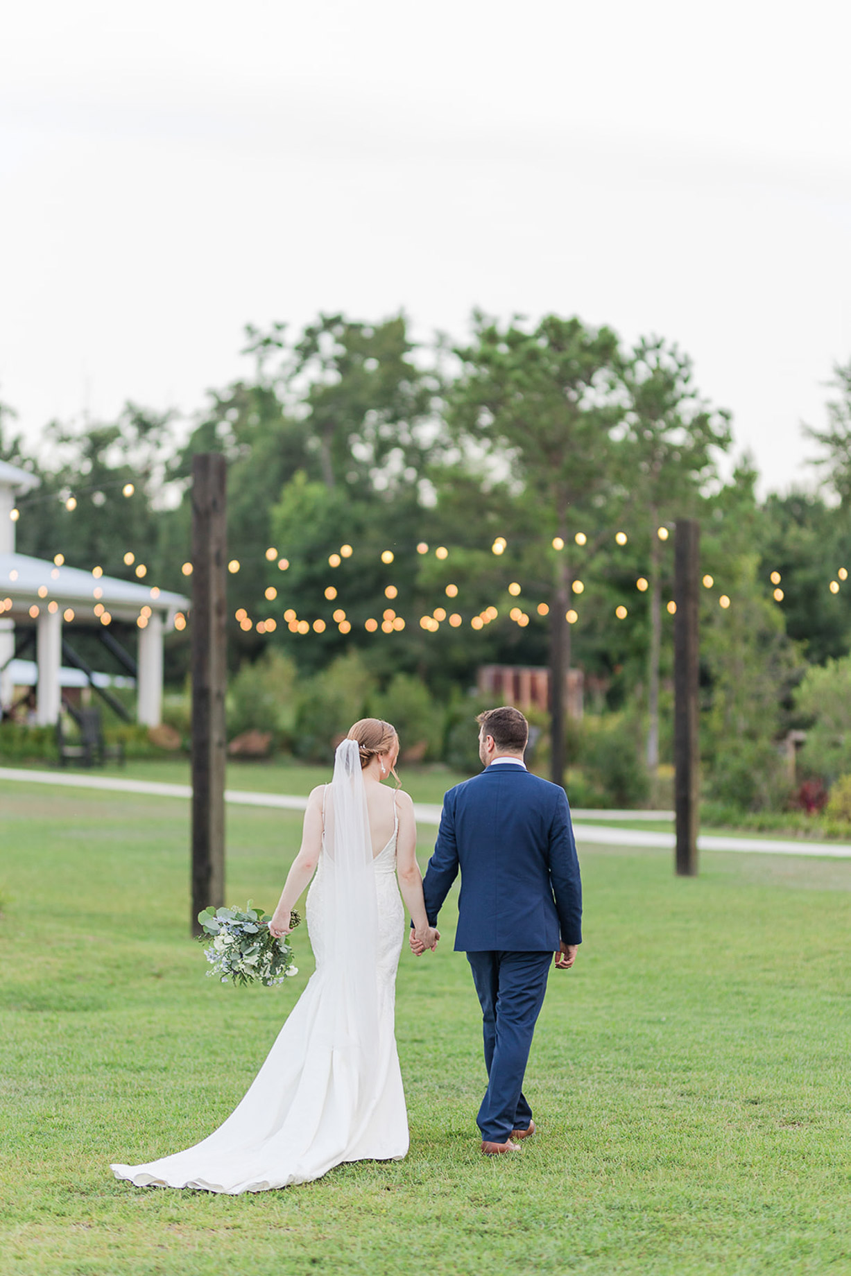 Couple walking under the cafe lights of the Emerald Courtyard