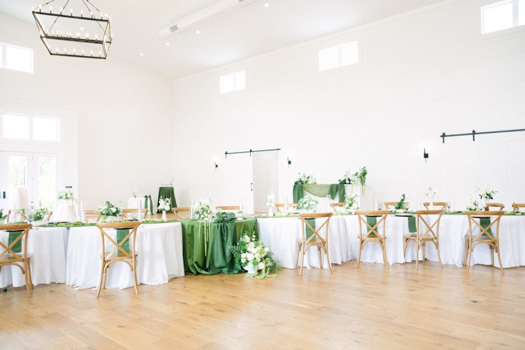 A shades of green and white combination for this modern organic floral wedding design. White linens accented with moss green velvet linens creating beautiful wedding table decor. 
