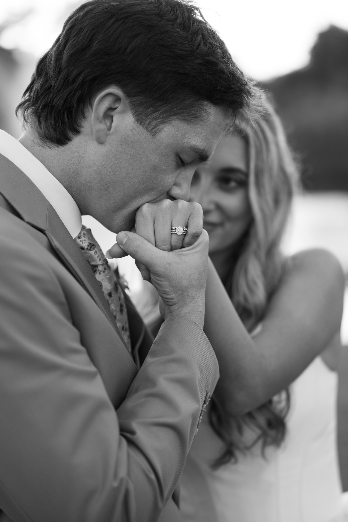 Black and white photo of a groom kissing his bride's hand at a Myrtle Beach wedding venue