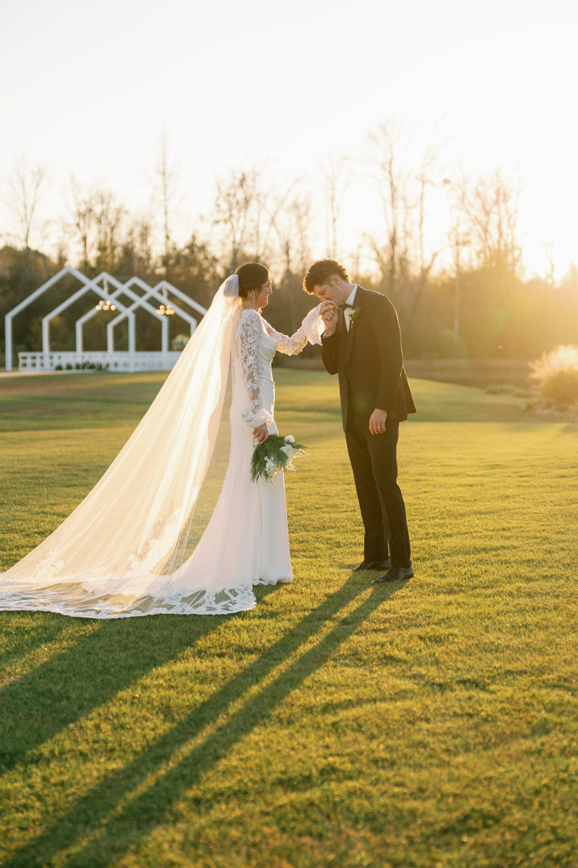 Couple on the sunny lawn at a December wedding at White Oaks Farm